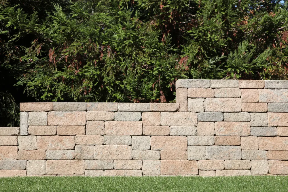 Stacked concrete block retaining wall terracing a landscaped yard in Asheville NC - The Asheville Concrete Company