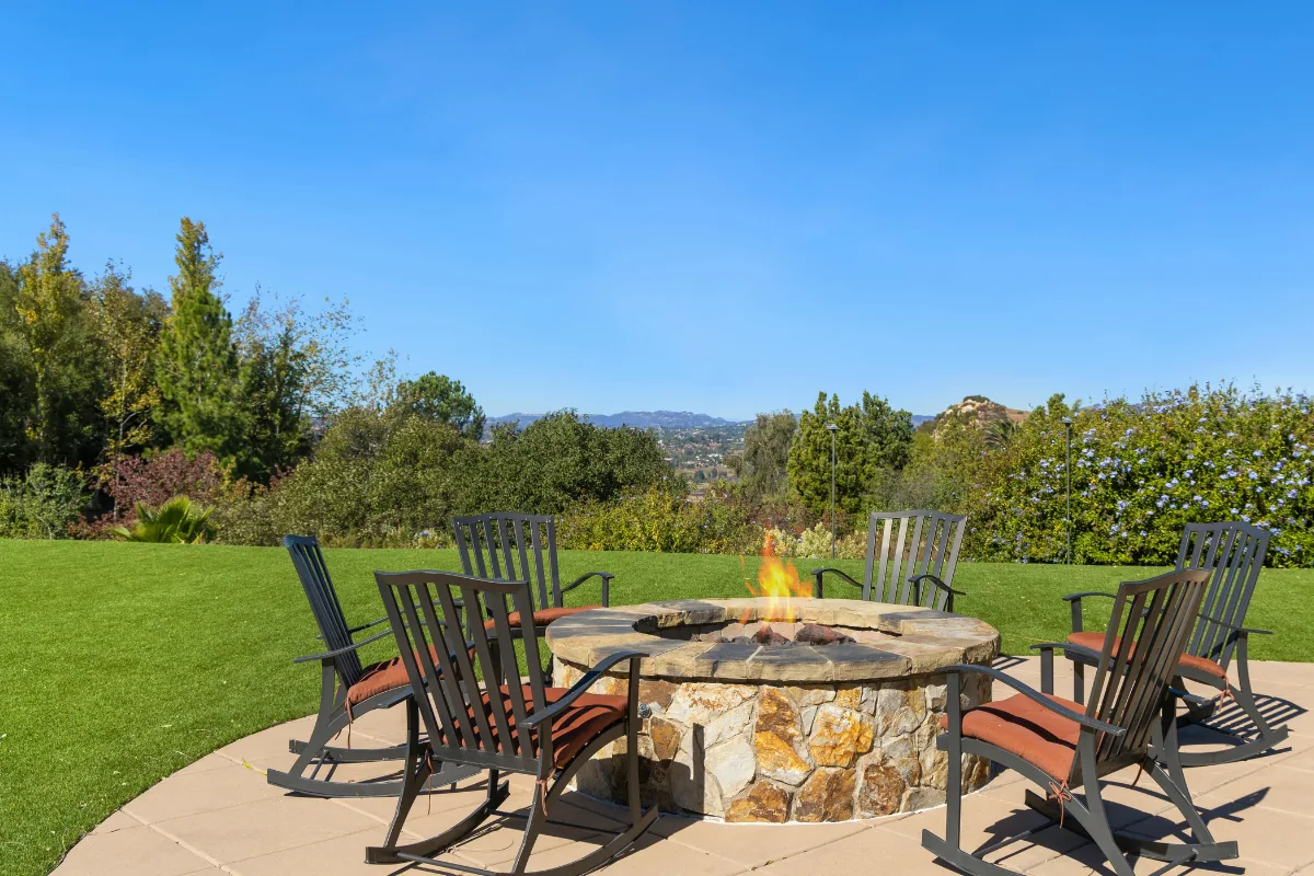 Poured concrete patio built around a stone fire pit with seating in Western NC - The Asheville Concrete Company