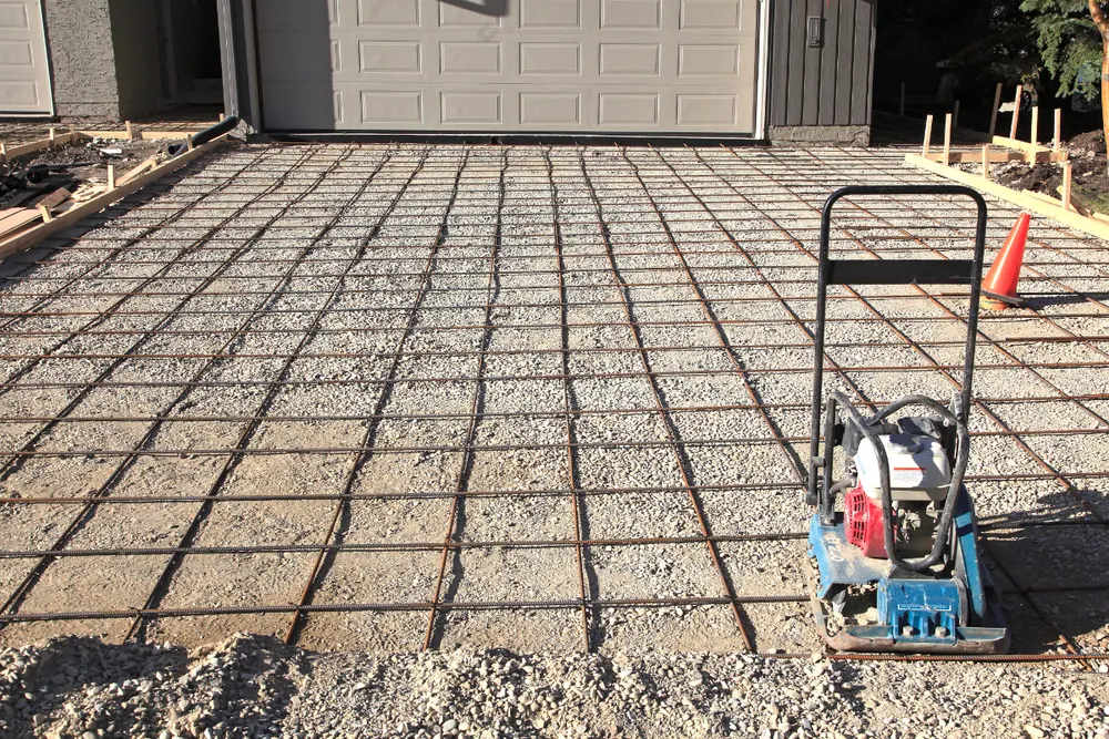 Rebar reinforcement and compacted base prep ahead of a driveway pour in Asheville NC - The Asheville Concrete Company